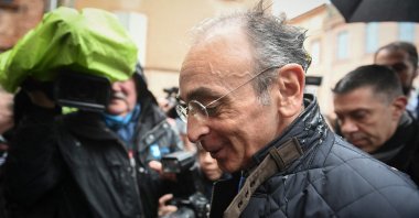 France's far-right party "Reconquete!" leader, media pundit and candidate for the 2022  presidential election Eric Zemmour reacts after being hit by an egg thrown by an unidentified man, during a campaign visit in Moissac, southern France, on March 12, 2022. (AFP Photo)