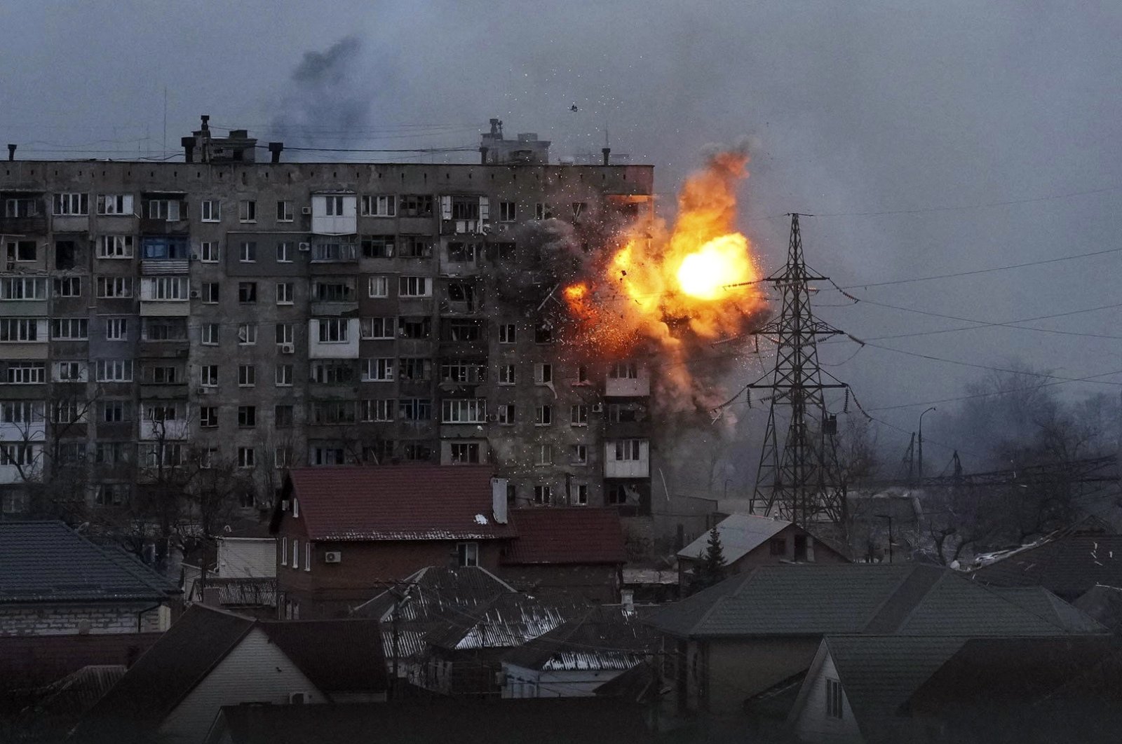 An explosion is seen in an apartment building after a Russian army tank fires in Mariupol, Ukraine, March 11, 2022. (AP Photo)