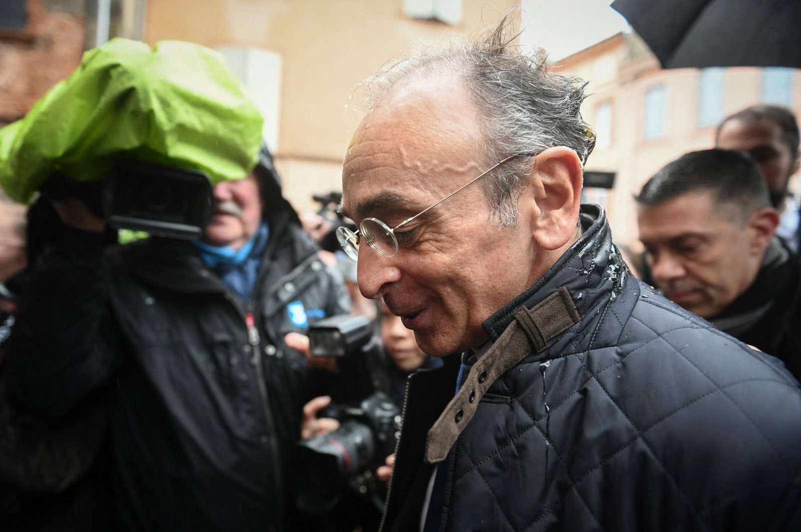France&#039;s far-right party &quot;Reconquete!&quot; leader, media pundit and candidate for the 2022  presidential election Eric Zemmour reacts after being hit by an egg thrown by an unidentified man, during a campaign visit in Moissac, southern France, on March 12, 2022. (AFP Photo)