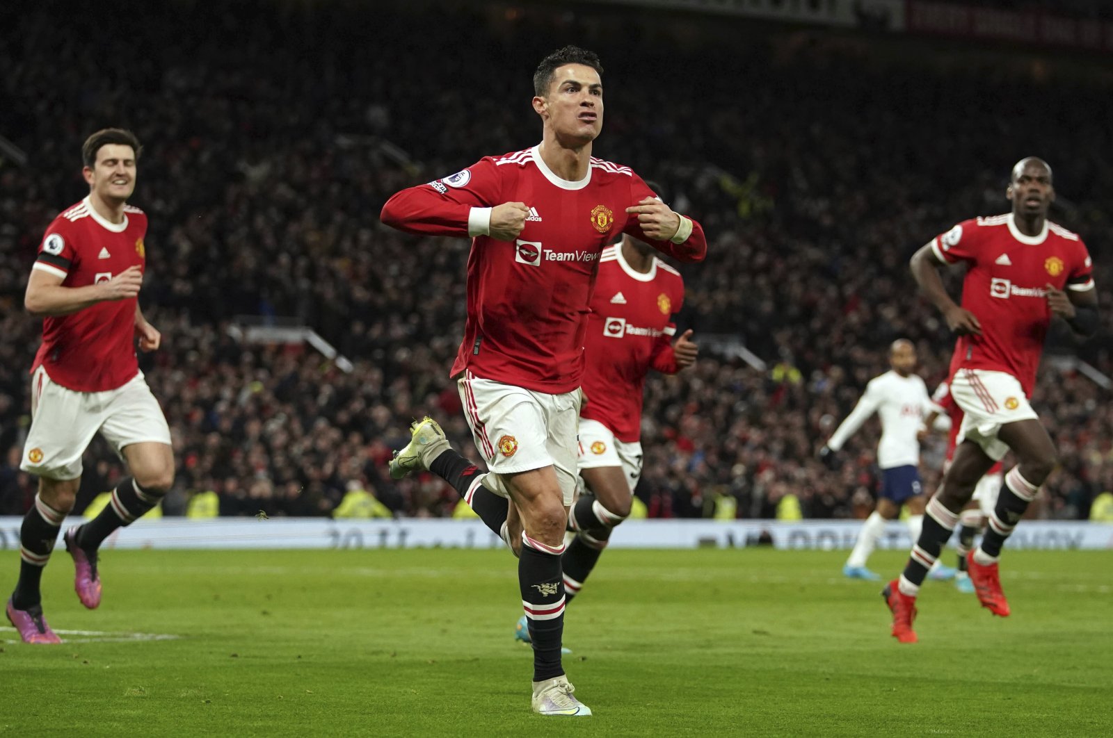 Manchester United&#039;s Cristiano Ronaldo (C) celebrates after scoring in a Premier League match against Tottenham Hotspur, Manchester, England, March 12, 2022. (AP Photo)