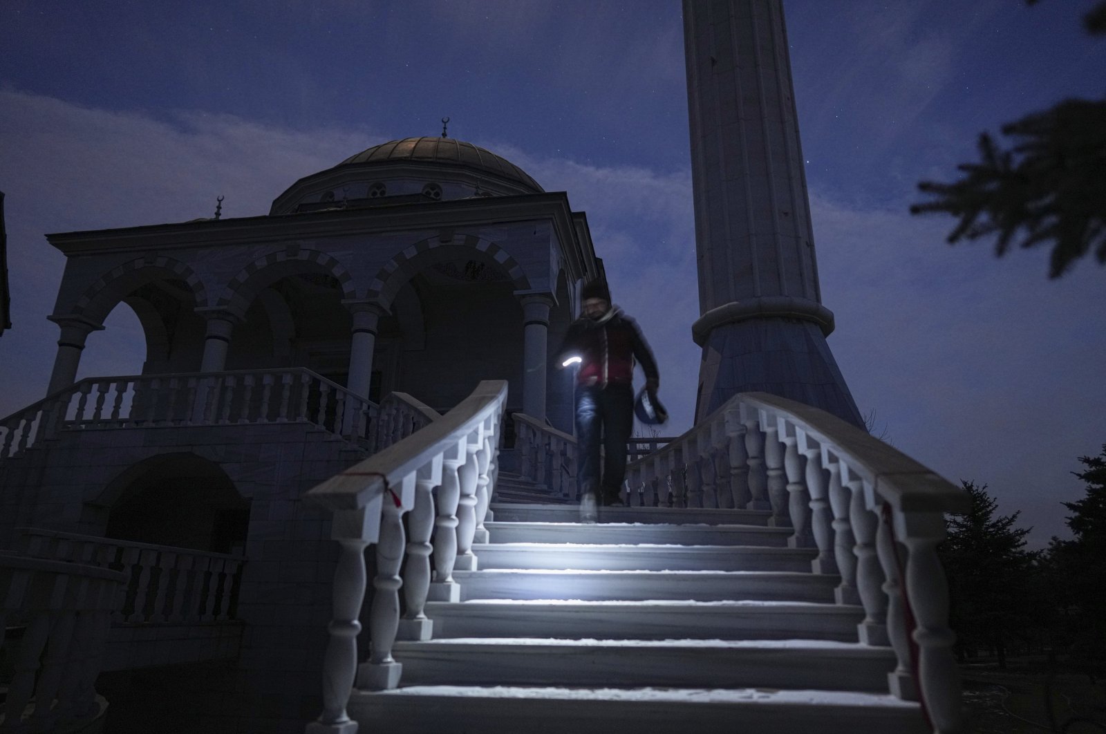 Turkish imam Mehmet Yüce walks down the steps after evening prayers in a mosque in Mariupol, Ukraine, March 12, 2022. (AP Photo)