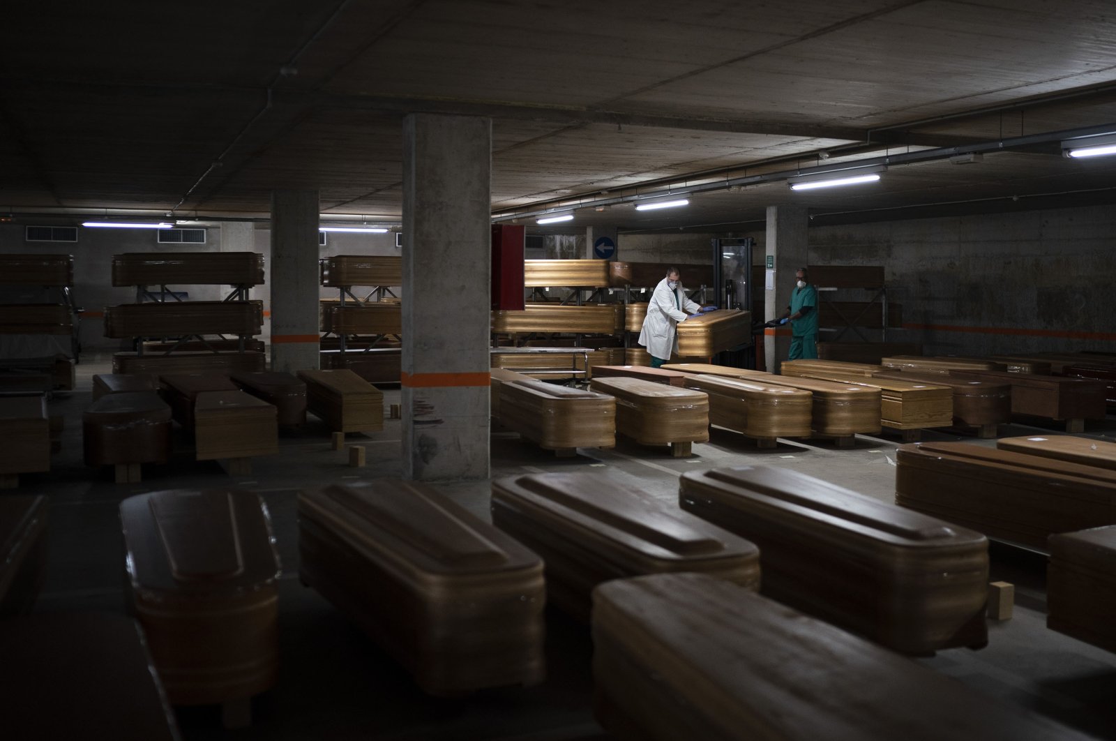 Coffins carrying the bodies of people who died of coronavirus and are waiting to be buried or incinerated in an underground parking lot at the Collserola funeral home in Barcelona, Spain, April 2, 2020. (AP Photo)