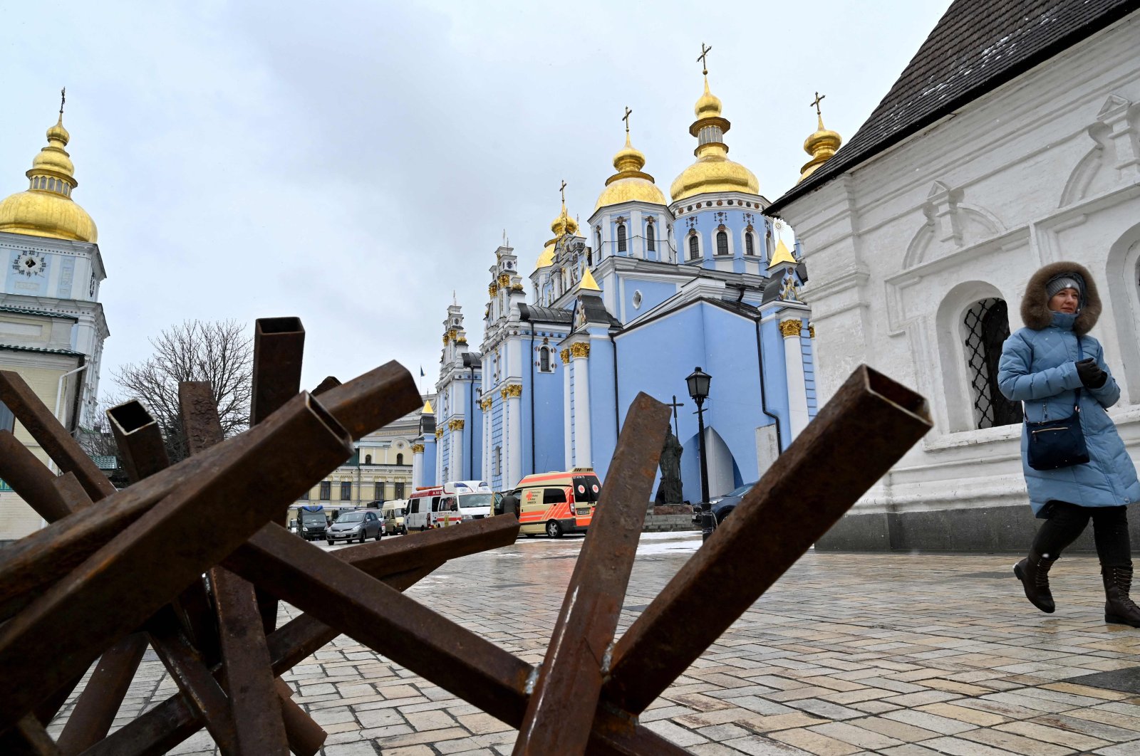 A woman leave the Mykhailo Golden-Domes Cathedral after a service for the Ukrainians who died in the Russian-Ukrainian War, held by Epiphanius, primate of the Orthodox Church of Ukraine, in Kyiv on March 13, 2022. (AFP Photo)