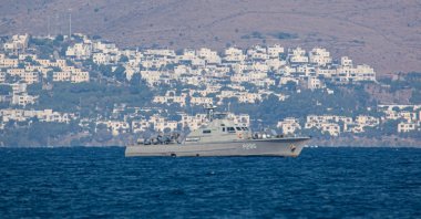 A Greek patrol ship of the Hellenic Navy is patrolling the Aegean Sea water borders between Greece and Turkey, just outside Kos Island with Turkey in the background with summer houses, resorts and hotels visible. Nov. 16, 2021 (AFP File Photo)