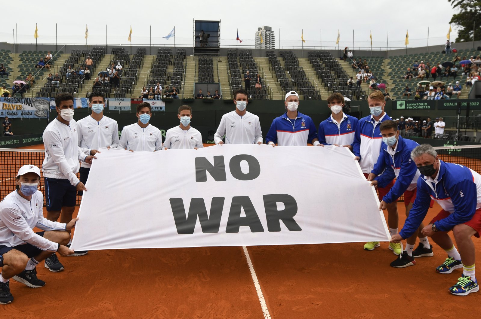 Argentina (L) and Czech players hold an anti-war banner before a Davis Cup match, Buenos Aires, Argentina, March 4, 2022. (AP Photo)