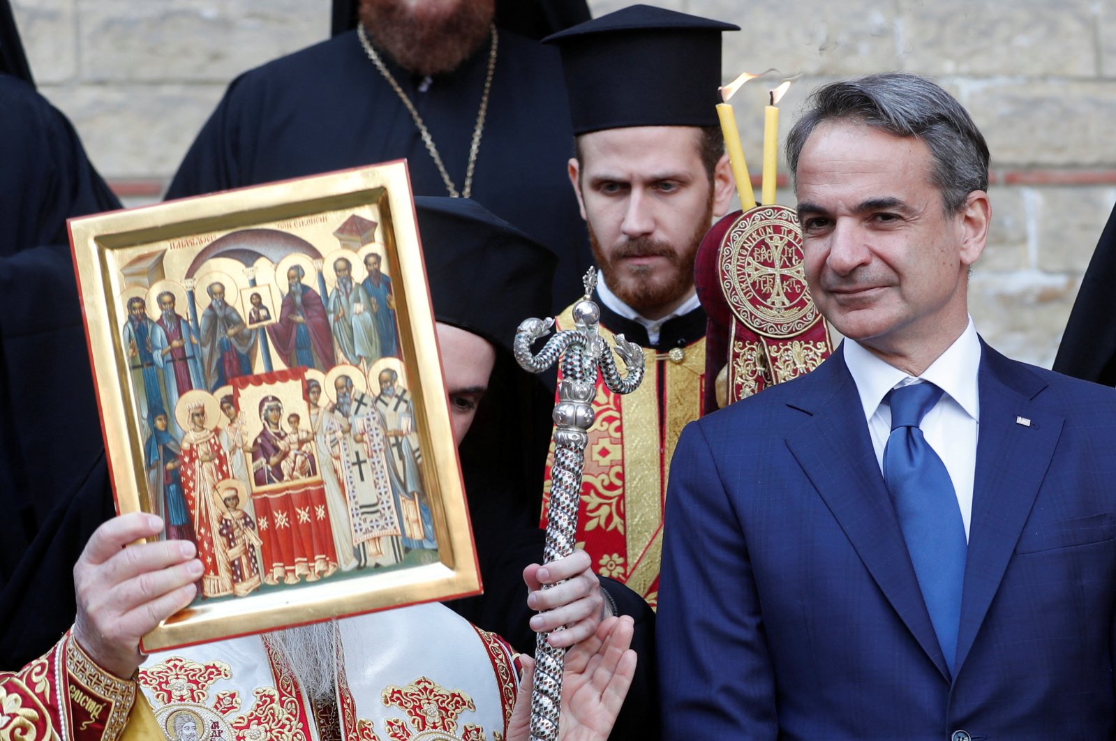 Ecumenical Patriarch Bartholomew I, the spiritual head of some 300 million Orthodox Christians worldwide, holds an icon as Greek Prime Minister Kyriakos Mitsotakis looks on at the courtyard of the Ecumenical Patriarchate following a Sunday service in Istanbul, Turkey, March 13, 2022. (Reuters Photo)