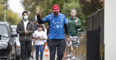 Temel Ataçocuğu gestures as he completes his walk, in Christchurch, New Zealand, March 15, 2022. (AP PHOTO)