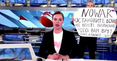 An anti-war protester interrupts a live news bulletin on Russia's state TV "Channel One" holding up a sign at an unknown location in Russia, March 14, 2022. (Reuters Photo)