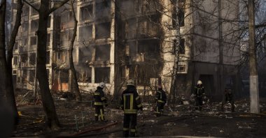 Firefighters work at the scene of an apartment building bombing in Kyiv, Ukraine, March 15, 2022. (AP Photo)
