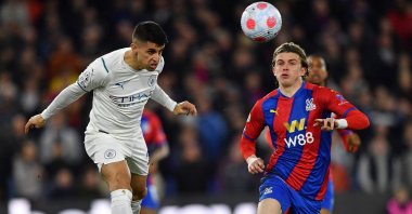 Man City's Joao Cancelo (L) heads the ball past Crystal Palace's Conor Gallagher in a Premier League match, London, England, March 14, 2022. (AFP Photo)
