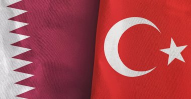 The flags of Turkey and Qatar folded together. (Shutterstock)