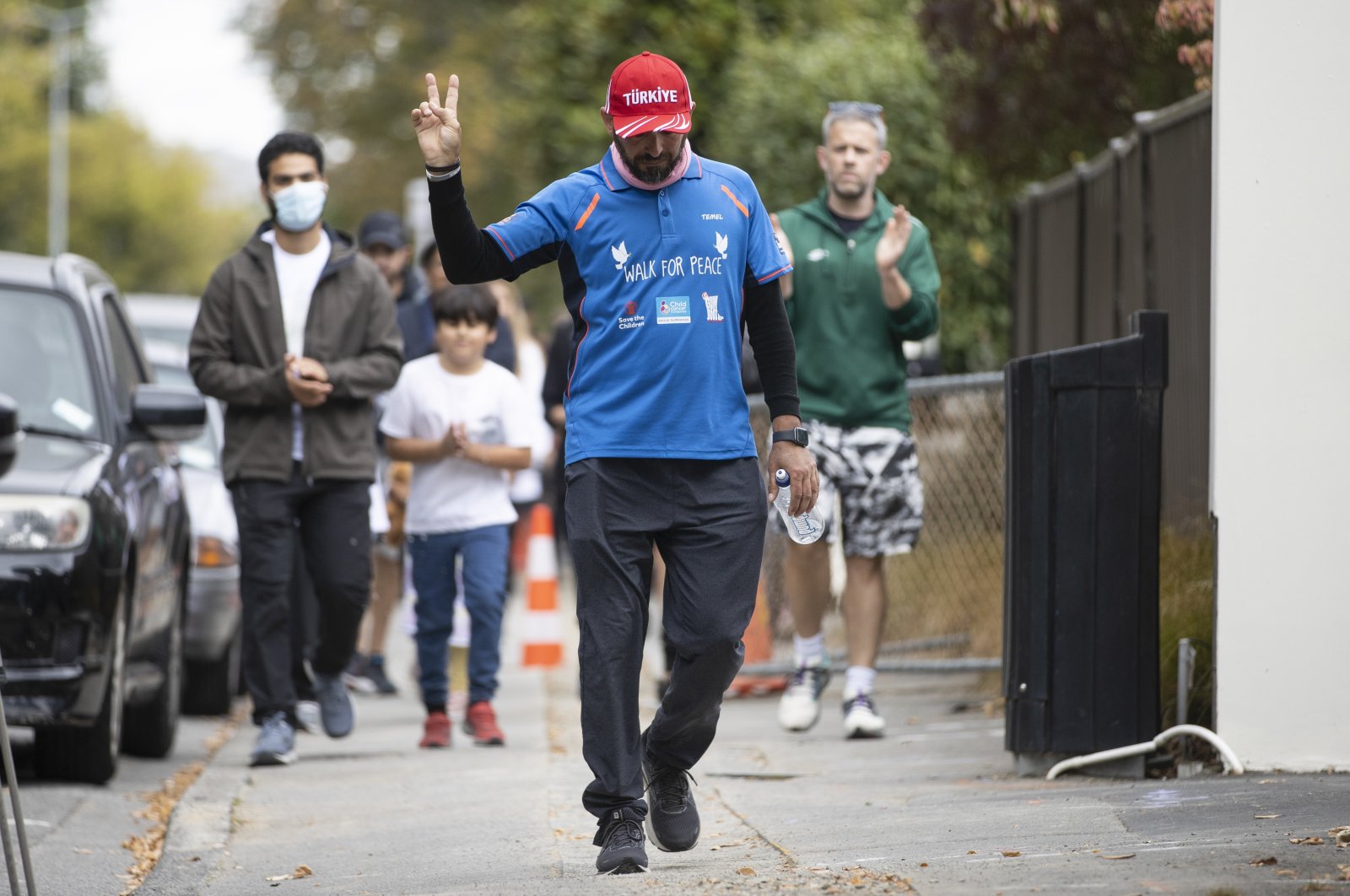 Temel Ataçocuğu gestures as he completes his walk, in Christchurch, New Zealand, March 15, 2022. (AP PHOTO)