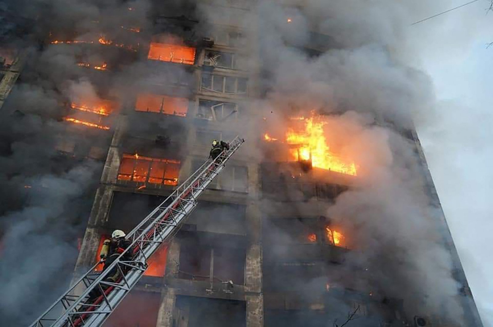 Firefighters work to extinguish a fire in a housing block hit by shelling in the Sviatoshynskyi district in western Kyiv, Ukraine, March 15, 2022. (State Emergency Service of Ukraine Handout Photo via AFP)