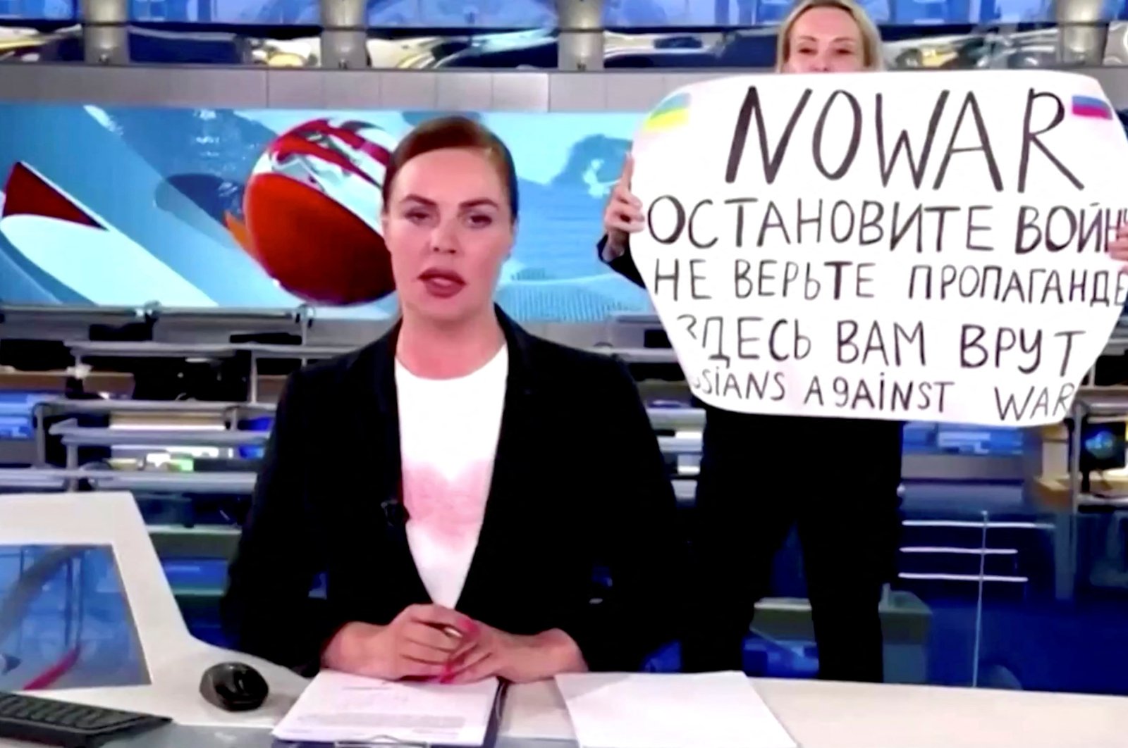 An anti-war protester interrupts a live news bulletin on Russia&#039;s state TV "Channel One" holding up a sign at an unknown location in Russia, March 14, 2022. (Reuters Photo)