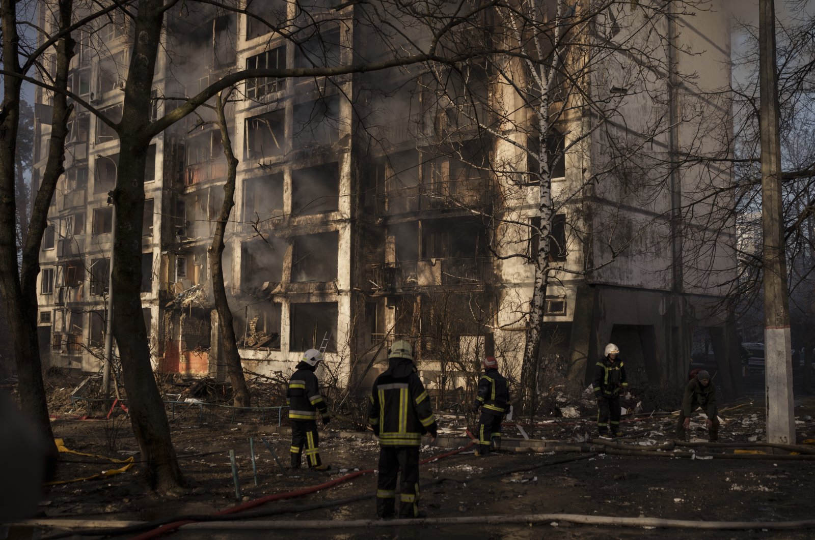 Firefighters work at the scene of an apartment building bombing in Kyiv, Ukraine, March 15, 2022. (AP Photo)