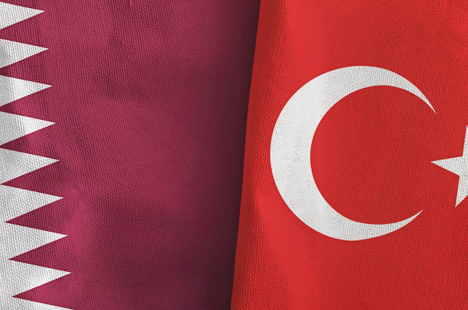 The flags of Turkey and Qatar folded together. (Shutterstock)