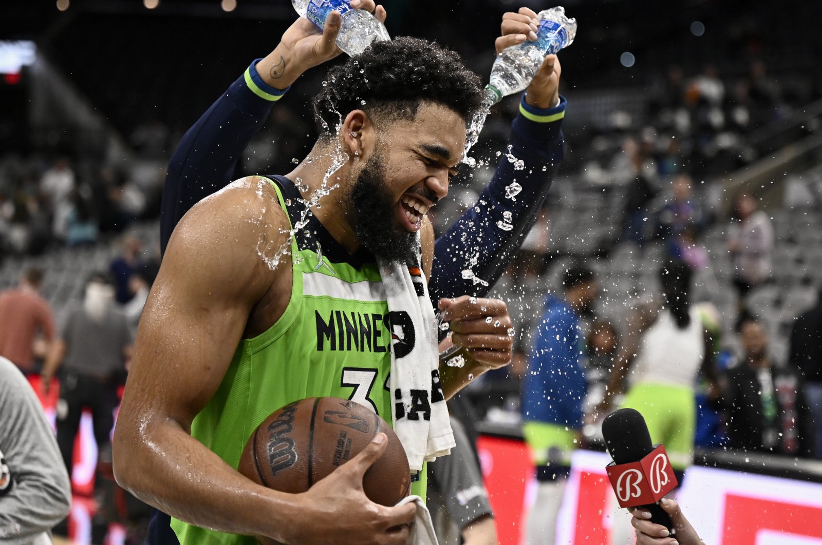 Timberwolves center Karl-Anthony Towns is doused by teammate D&#039;Angelo Russell after an NBA game against the Spurs, San Antonio, Texas, U.S., March 14, 2022. (AP Photo)