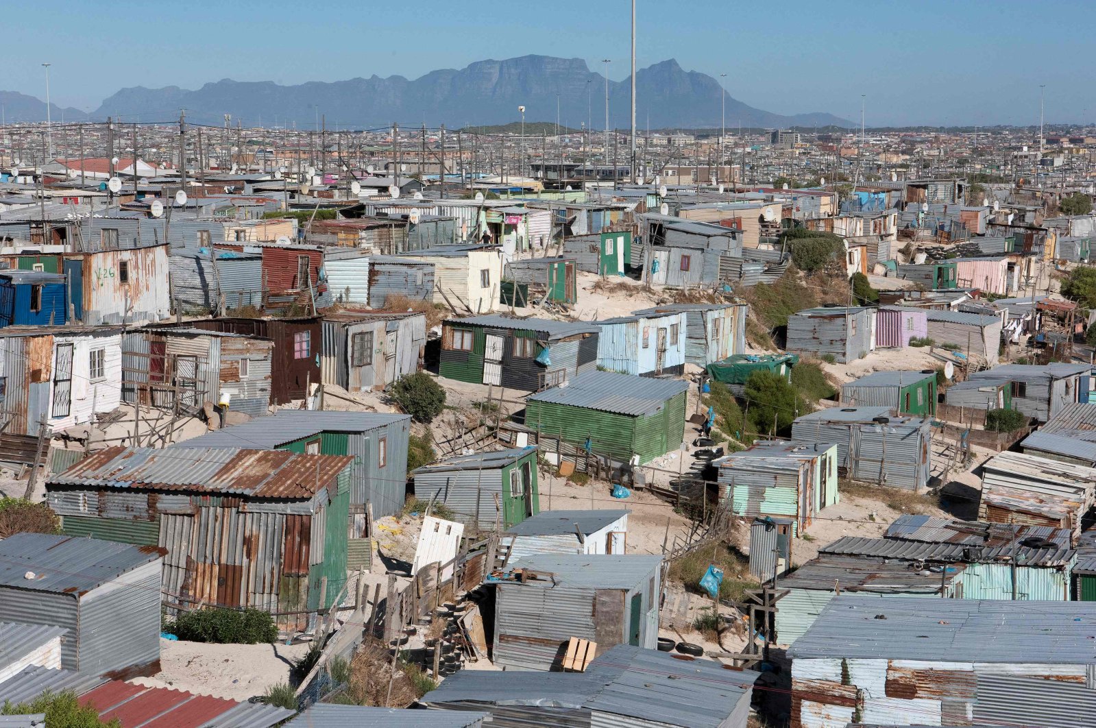 A general view of informal settlements and other parts of Khayelitsha, home to millions of people in mostly impoverished circumstances, with the back of Table Mountain visible, near Cape Town, South Africa, Feb. 24, 2022. (AFP Photo) 
