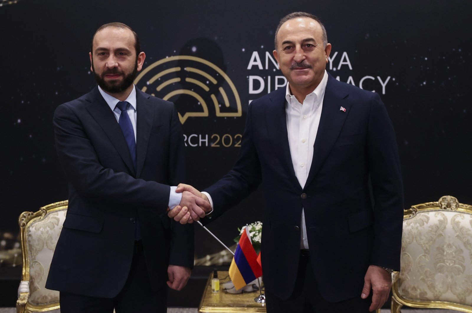 Foreign Minister Mevlüt Çavuşoğlu (R) shakes hands with Armenia&#039;s Foreign Minister Ararat Mirzoyan on the sidelines of the Antalya Diplomacy Forum in Antalya, Turkey, March 12, 2022. (AP Photo)