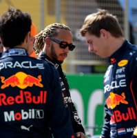 Mercedes' Lewis Hamilton (C) walks past Red Bull's Max Verstappen (R) during the first day of F1 preseason testing, Sakhir, Bahrain, March 12, 2021. (AFP Photo)