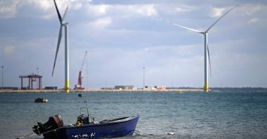 Wind turbines are pictured at the Taranto offshore wind turbines farm in Taranto, southern Italy, March 9, 2022. (Photo by Filippo MONTEFORTE / AFP)