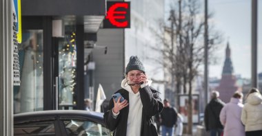 A Russian woman walks past a panel displaying the euro symbol at an exchange office in Moscow, Russia, March 15, 2022. (EPA Photo)