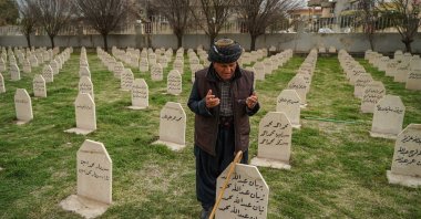 A man visits the grave of his lost ones at Halabja Cemetery on the 33rd anniversary of the Halabja chemical attack, which killed nearly 5,000 people and injured about 10,000, most of them civilians. (Reuters Photo)