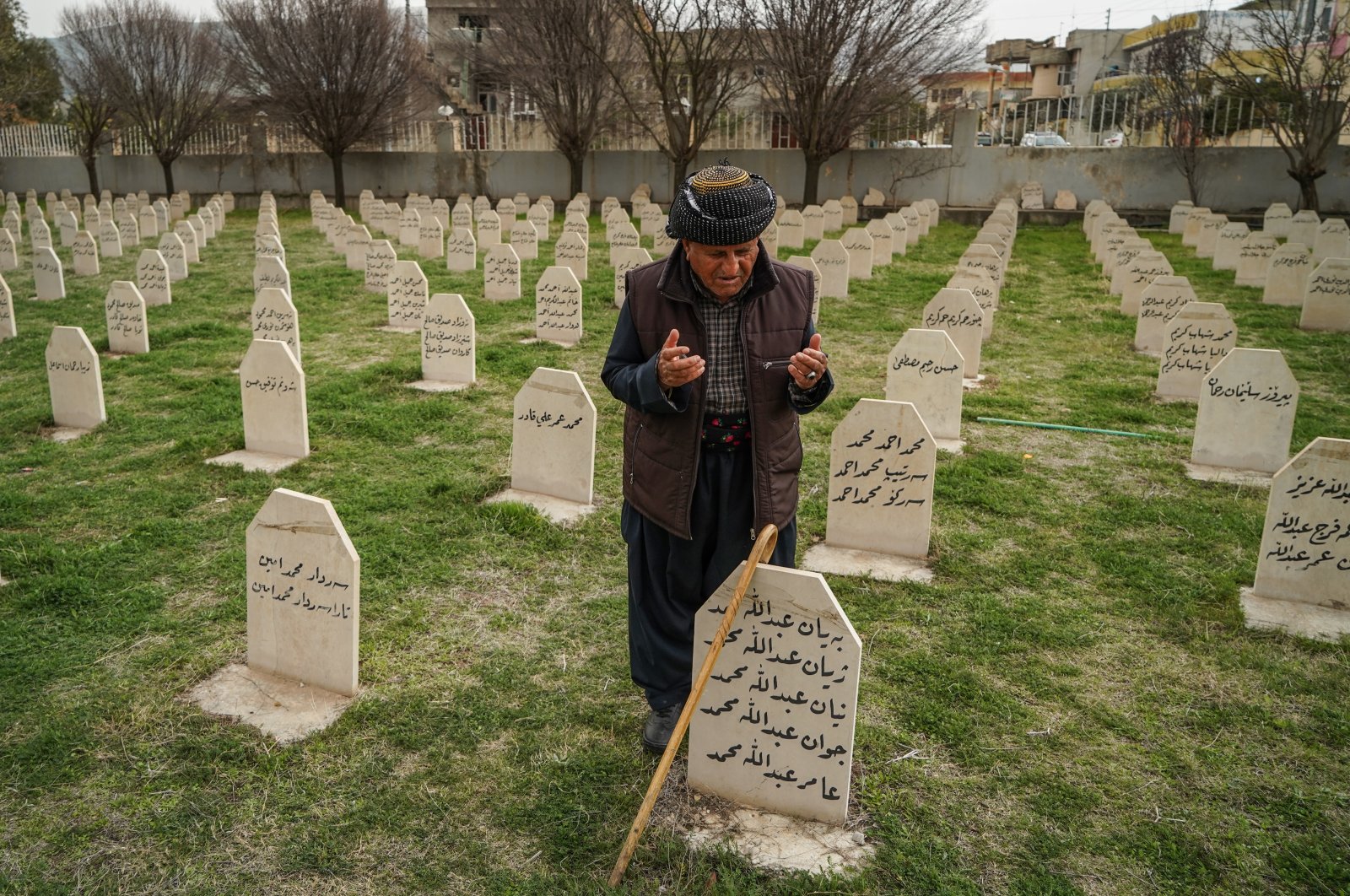 A man visits the grave of his lost ones at Halabja Cemetery on the 33rd anniversary of the Halabja chemical attack, which killed nearly 5,000 people and injured about 10,000, most of them civilians. (Reuters Photo)