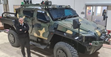 Nurol Makina General Manager Engin Aykol poses with a 4x4 tactical wheeled armored vehicles produced by company, Ankara, Turkey, March 17, 2022. (AA Photo) 