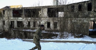 A soldier walks by an abandoned building destroyed during the Bosnian War on Mount Trebevic near the capital Sarajevo, Bosnia-Herzegovina, March 3, 2022. (AP Photo)