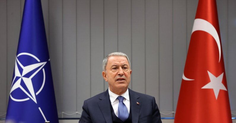 Defense Minister Hulusi Akar speaks to reporters after the NATO meeting in Brussels, March 16, 2022. (AA Photo)