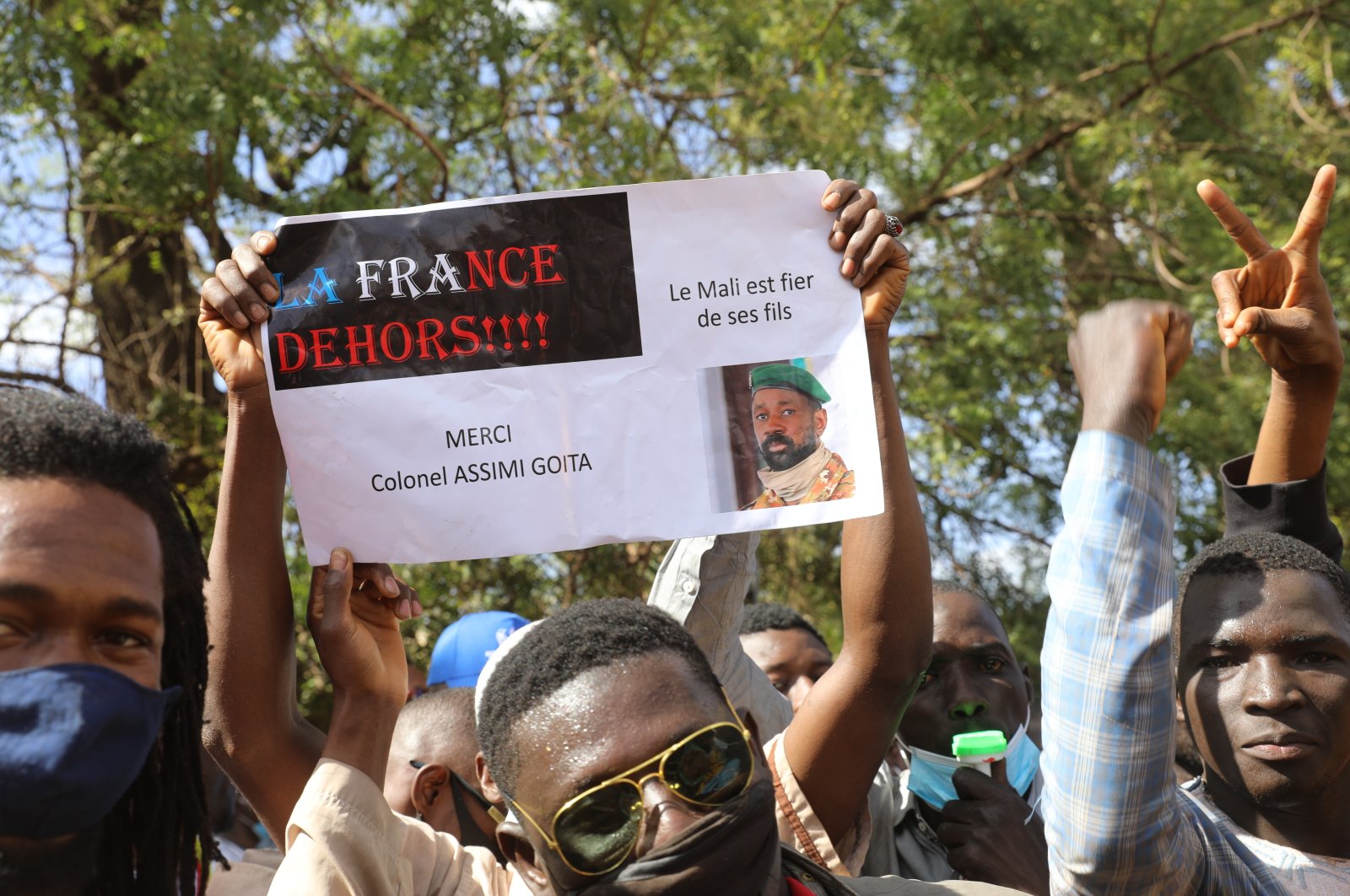 People join a government-sponsored rally in Mali&#039;s capital Bamako on Jan. 14, 2021, to protest new regional economic sanctions and growing pressure from former colonizer France, after Mali&#039;s military ruler pushed back promised elections by four years. Sign reads: &quot;France Out,&quot; &quot;Mali is proud of its sons&quot; and &quot;Thank you Colonel Assimi Goita.&quot; (AP Photo)
