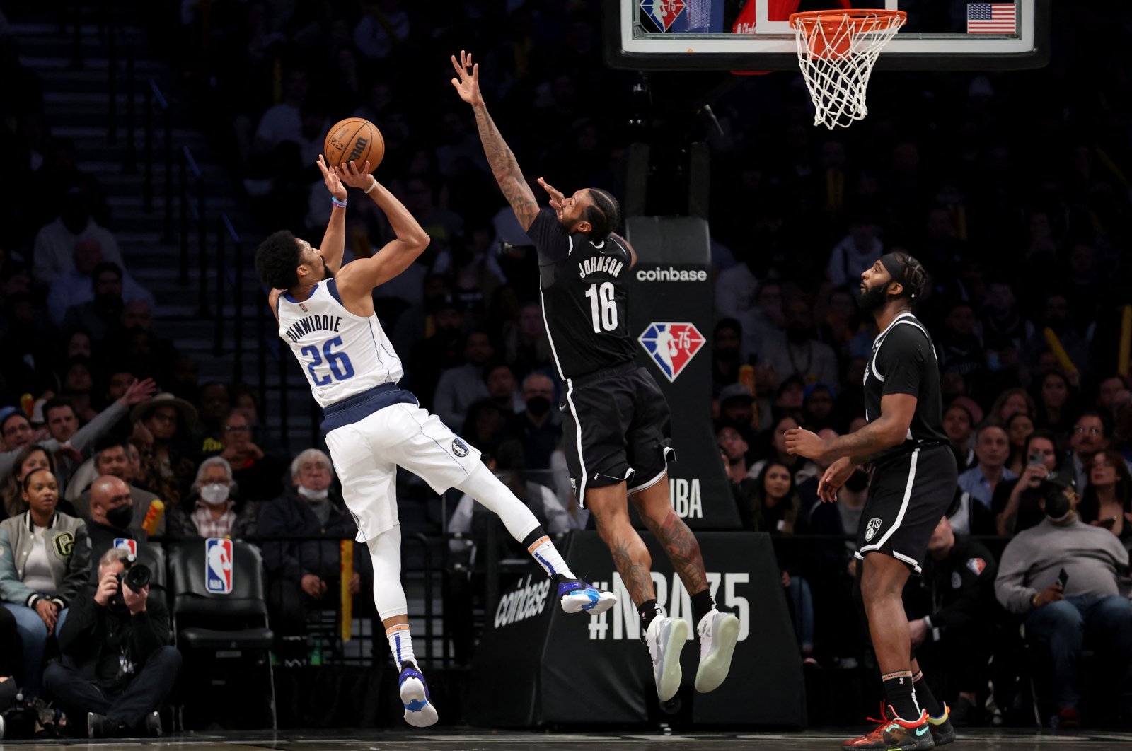 Dallas Mavericks guard Spencer Dinwiddie (L) shoots against Brooklyn Nets forward James Johnson (C) and center Andre Drummond (0) during an NBA game, Brooklyn, New York, U.S., March 16, 2022. (Reuters Photo)
