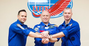 Left to right, Russian cosmonauts Oleg Artemyev, Denis Matveev and Sergey Korsakov pose for a picture during a news conference ahead of the expedition to the International Space Station (ISS) at the Baikonur Cosmodrome, Kazakhstan, March 17, 2022. (Roscosmos Handout via Reuters)