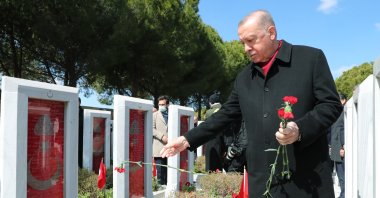 President Recep Tayyip Erdoğan lays flowers on the graves of fallen soldiers, in Çanakkale, western Turkey, March 18, 2022. (AA PHOTO)