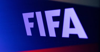 The FIFA logo is seen in front of the Russian flag in this illustration, Feb. 28, 2022. (Reuters Photo)