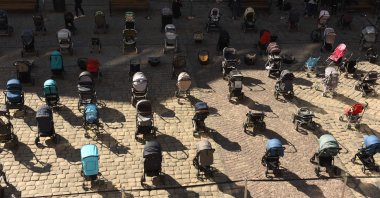 Exactly 109 empty strollers were placed outside the Lviv city council to remember the number of children killed in Russia's ongoing invasion of Ukraine, Lviv, Ukraine, March 18, 2022, (AFP Photo)