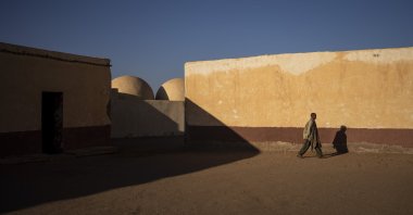 A Sahrawi man walks on the patio of a closed school in Bir Lahlou, Western Sahara, Oct. 13, 2021. (AP Photo)