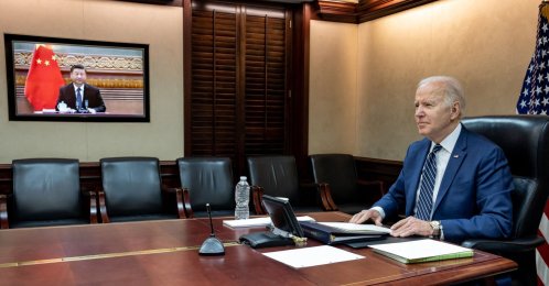 In this image released by the White House, U.S. President Joe Biden (L) speaks with Chinese President Xi Jinping (on screen) from the White House in Washington, DC, March 18, 2022. (AFP Photo)