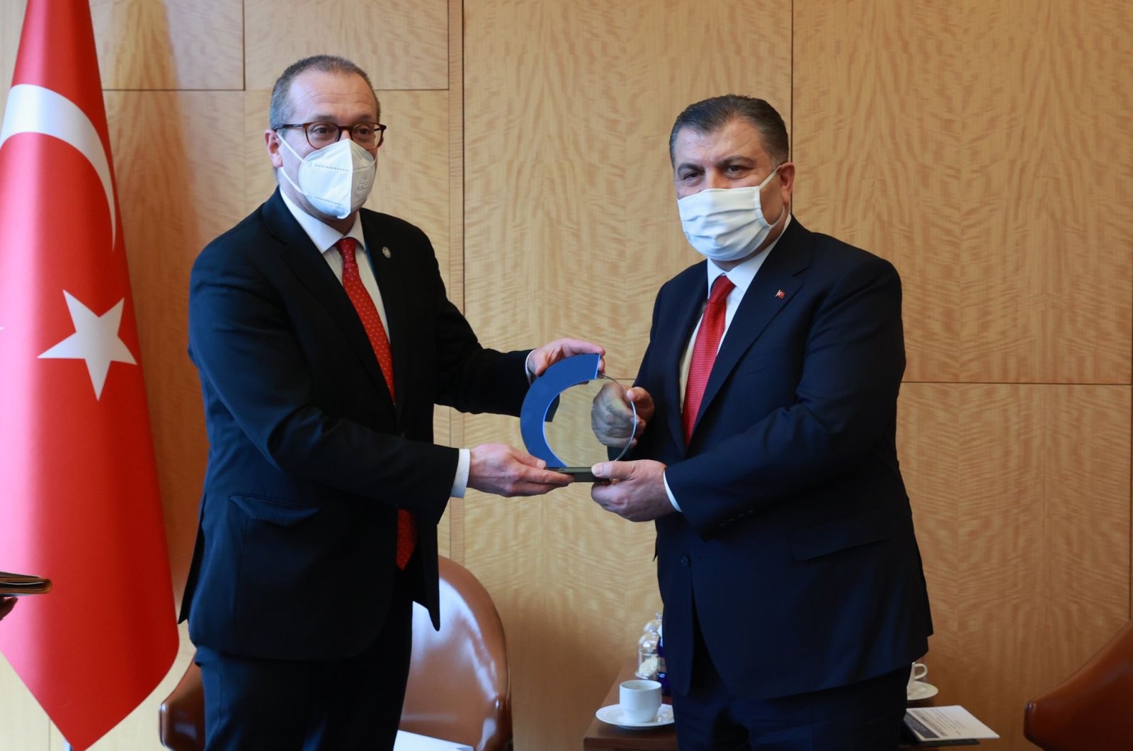 WHO Regional Director for Europe Hans Kluge (L) presents an award to Health Minister Fahrettin Koca, in Istanbul, Turkey, March 17, 2022. (AA Photo)