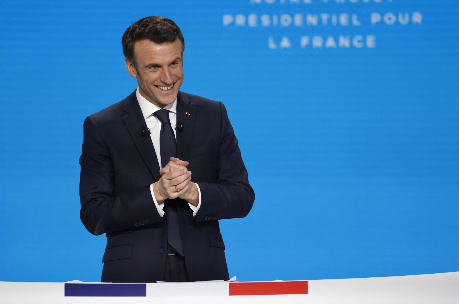France&#039;s President Emmanuel Macron reacts during a press conference to present his political program ahead of the April 10/24 presidential election in France, in Paris&#039; suburban city of Aubervilliers, March 17, 2022. (AFP Photo)