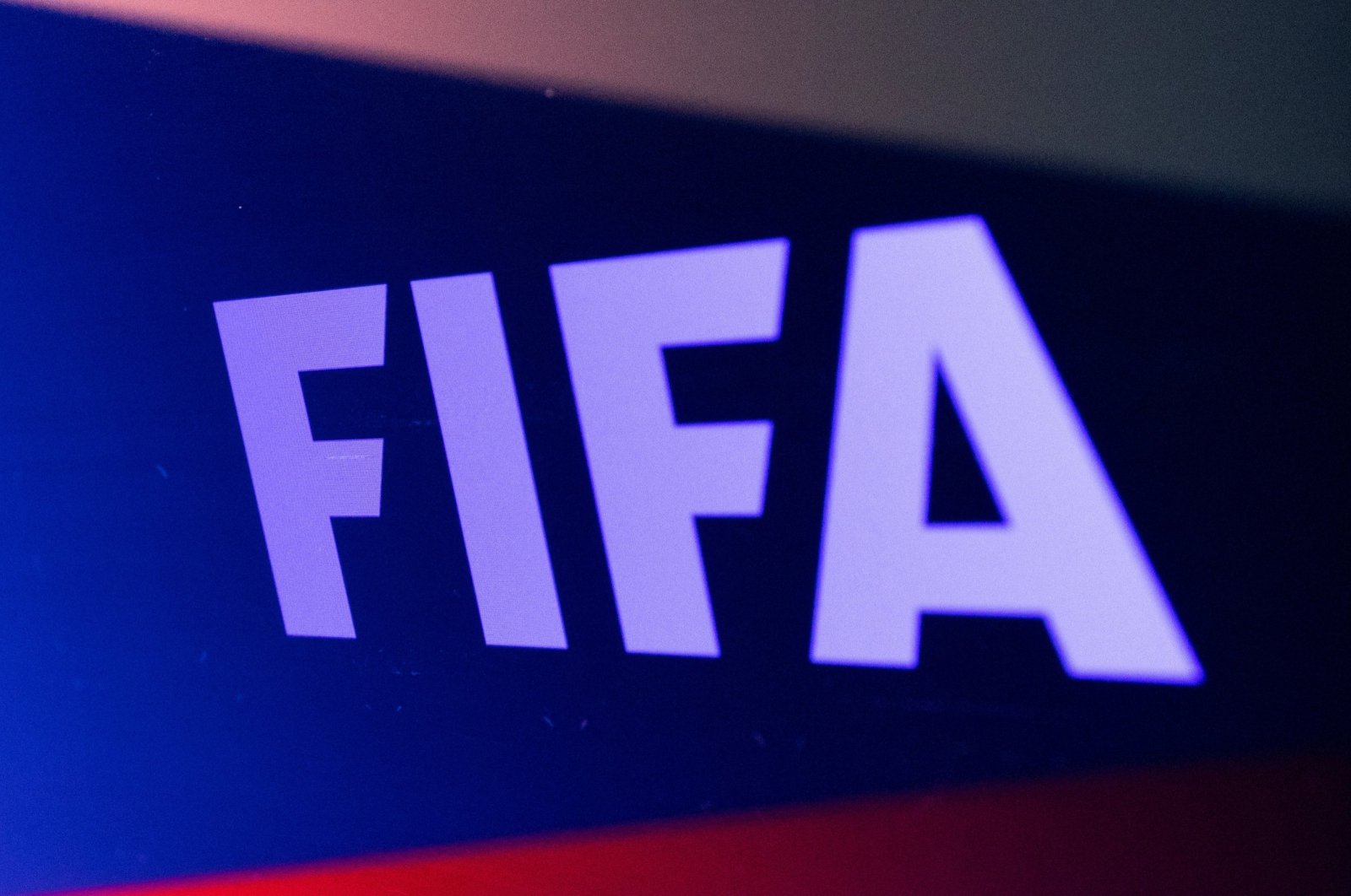 The FIFA logo is seen in front of the Russian flag in this illustration, Feb. 28, 2022. (Reuters Photo)