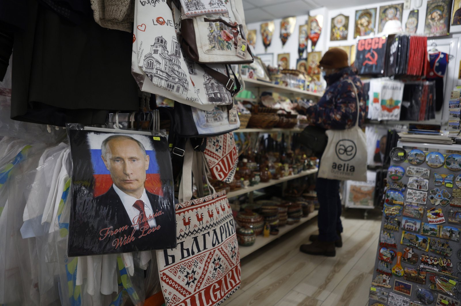 A photo of Russian President Putin signed &quot;From Russia with love&quot; is seen on a T-shirt in a souvenir shop in Sofia, March 17, 2022. (AP Photo)