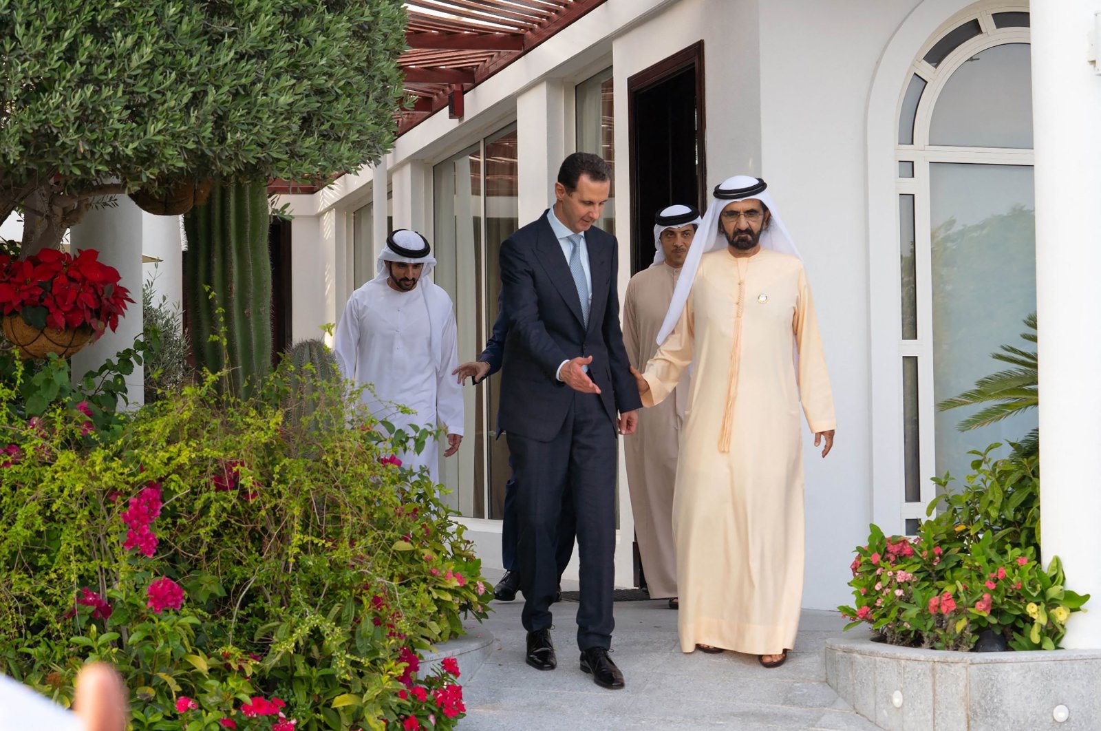 A handout picture released by the Syrian Presidency Facebook page on March 18, 2022, shows Syria&#039;s Bashar Assad welcomed by the UAE&#039;s Vice President and Prime Minister Sheikh Mohammed bin Rashid Al Maktoum, in the Emirate of Dubai. (AFP Photo)
