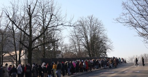 Refugees who fled Russia's invasion of Ukraine wait in a queue to obtain Polish national identification number (PESEL) in front of National Stadium in Warsaw, Poland, March 19, 2022. (REUTERS)