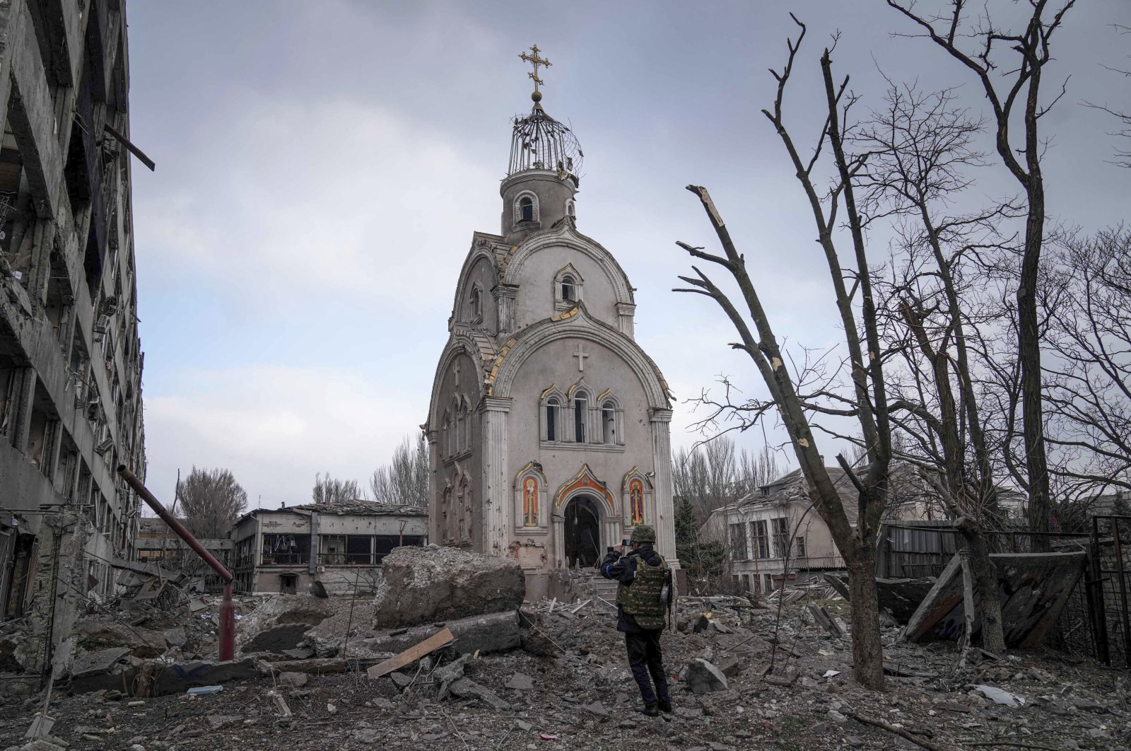 An Ukrainian soldier takes a photograph of a damaged church after shelling in a residential district in Mariupol, Ukraine, March 10, 2022. (AP Photo)