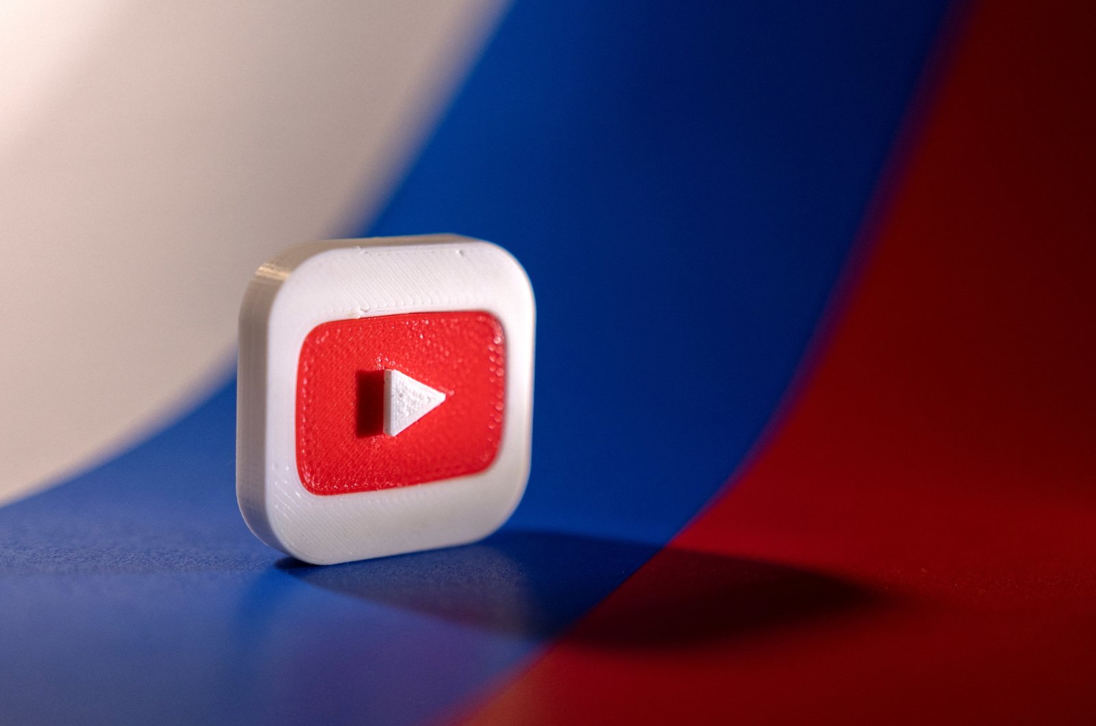 Youtube logo is placed on a Russian flag, Feb. 26, 2022. (Reuters Photo)