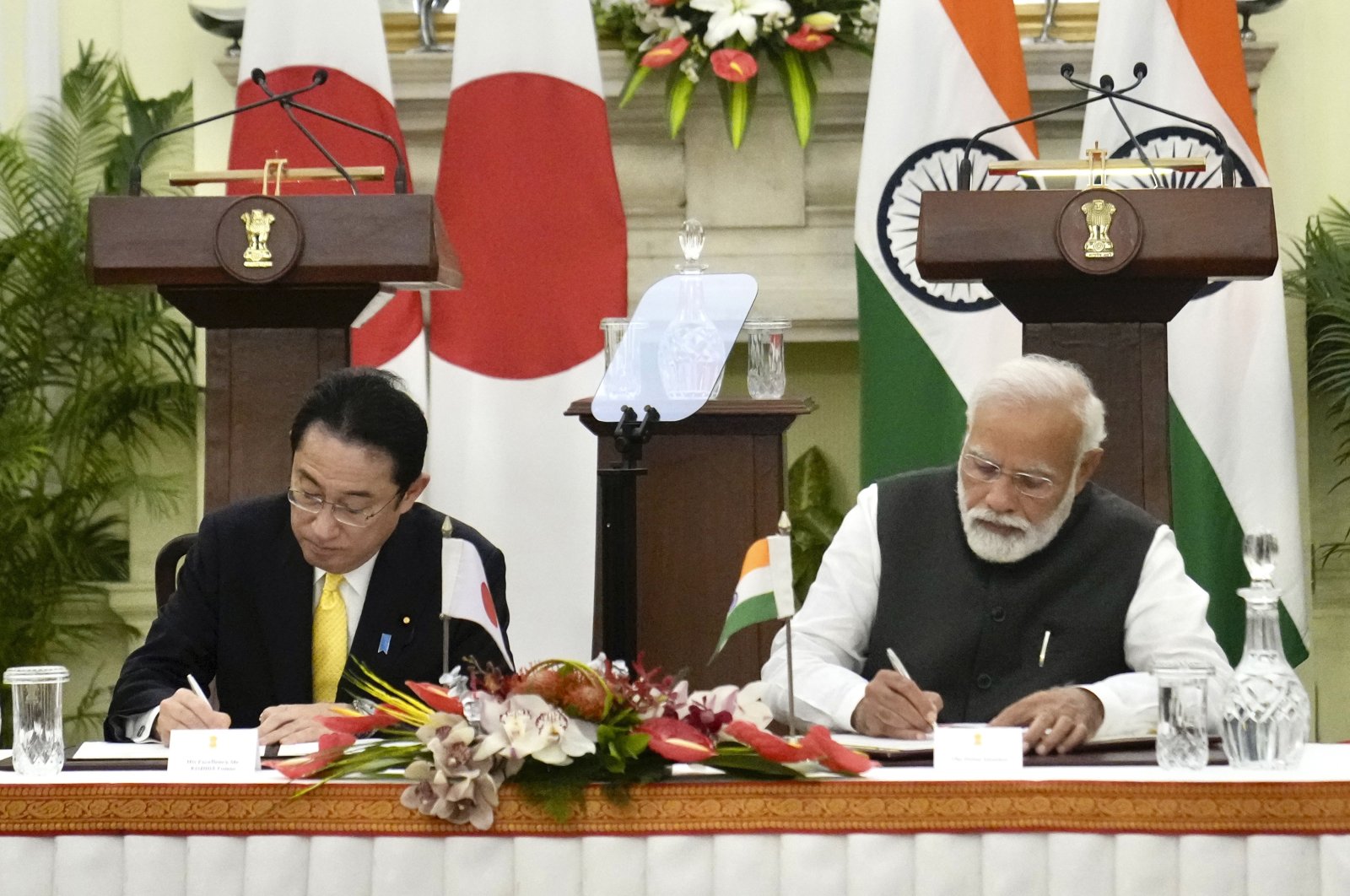 Indian Prime Minister Narendra Modi and his Japanese counterpart Fumio Kishida sign agreements in New Delhi, Saturday, March 19, 2022. (AP Photo/Manish Swarup)