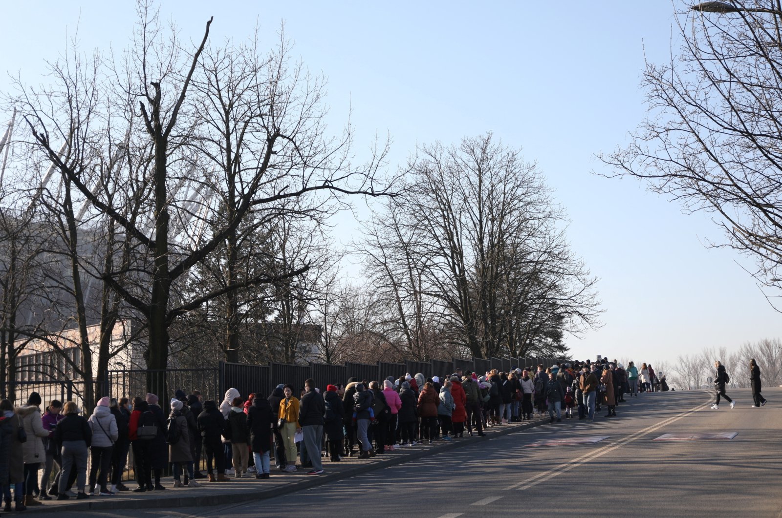 Refugees who fled Russia&#039;s invasion of Ukraine wait in a queue to obtain Polish national identification number (PESEL) in front of National Stadium in Warsaw, Poland, March 19, 2022. (REUTERS)