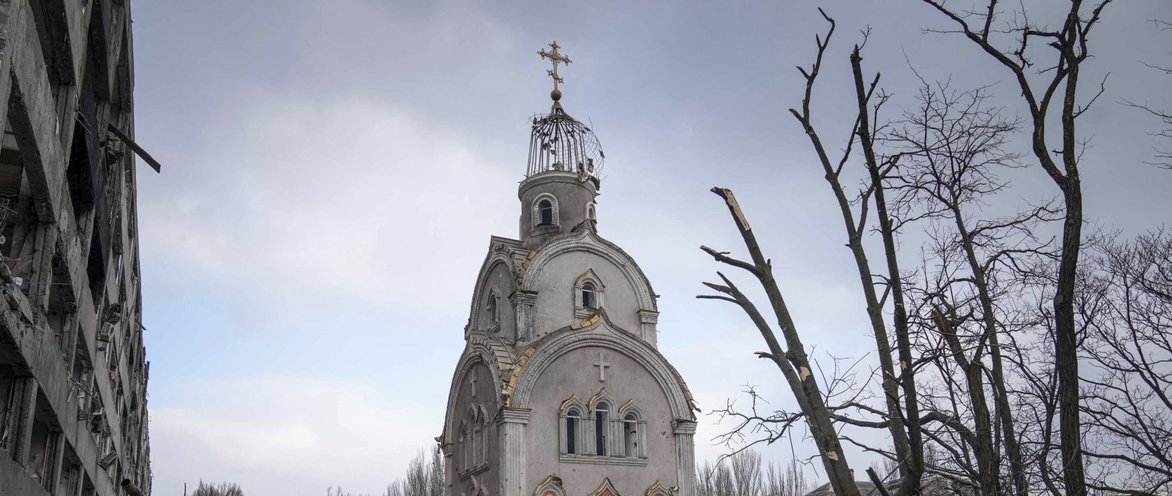 An Ukrainian soldier takes a photograph of a damaged church after shelling in a residential district in Mariupol, Ukraine, March 10, 2022. (AP Photo)